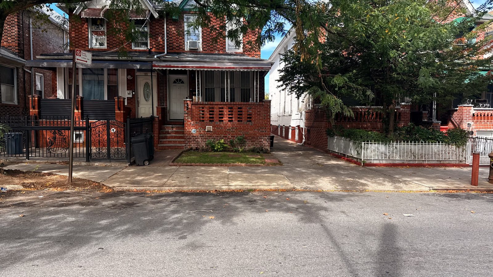 Existing two-story brick semi-attached house on a residential row in Brooklyn